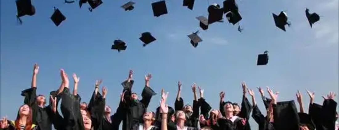 Graduating students throw their caps in the air