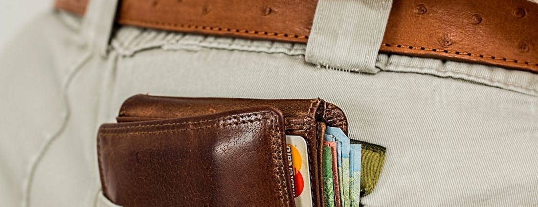 Wallet full of credit cards in mans back pocket
